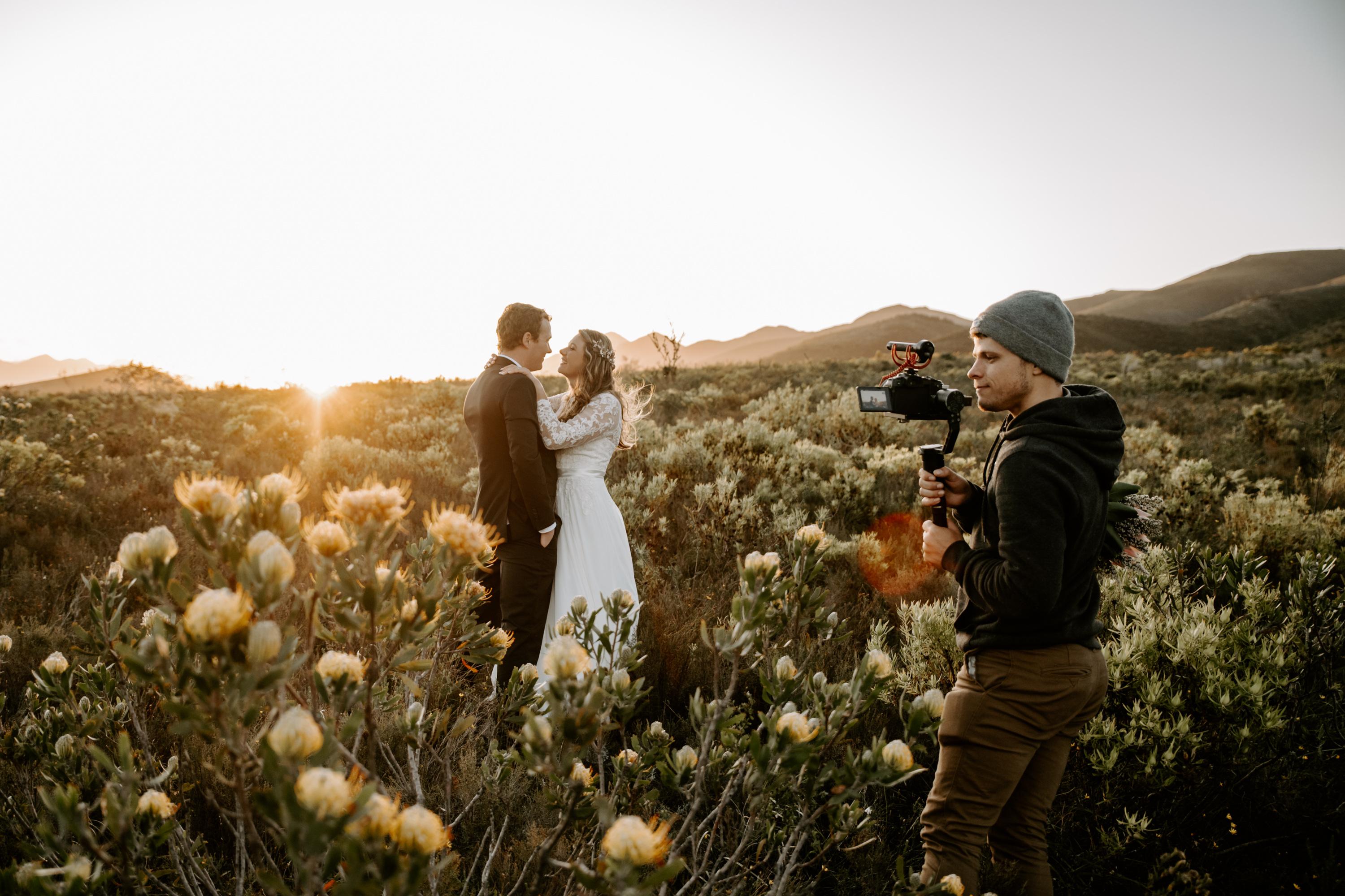 Jason Maggott filming a couple at golden hour in the protea fields